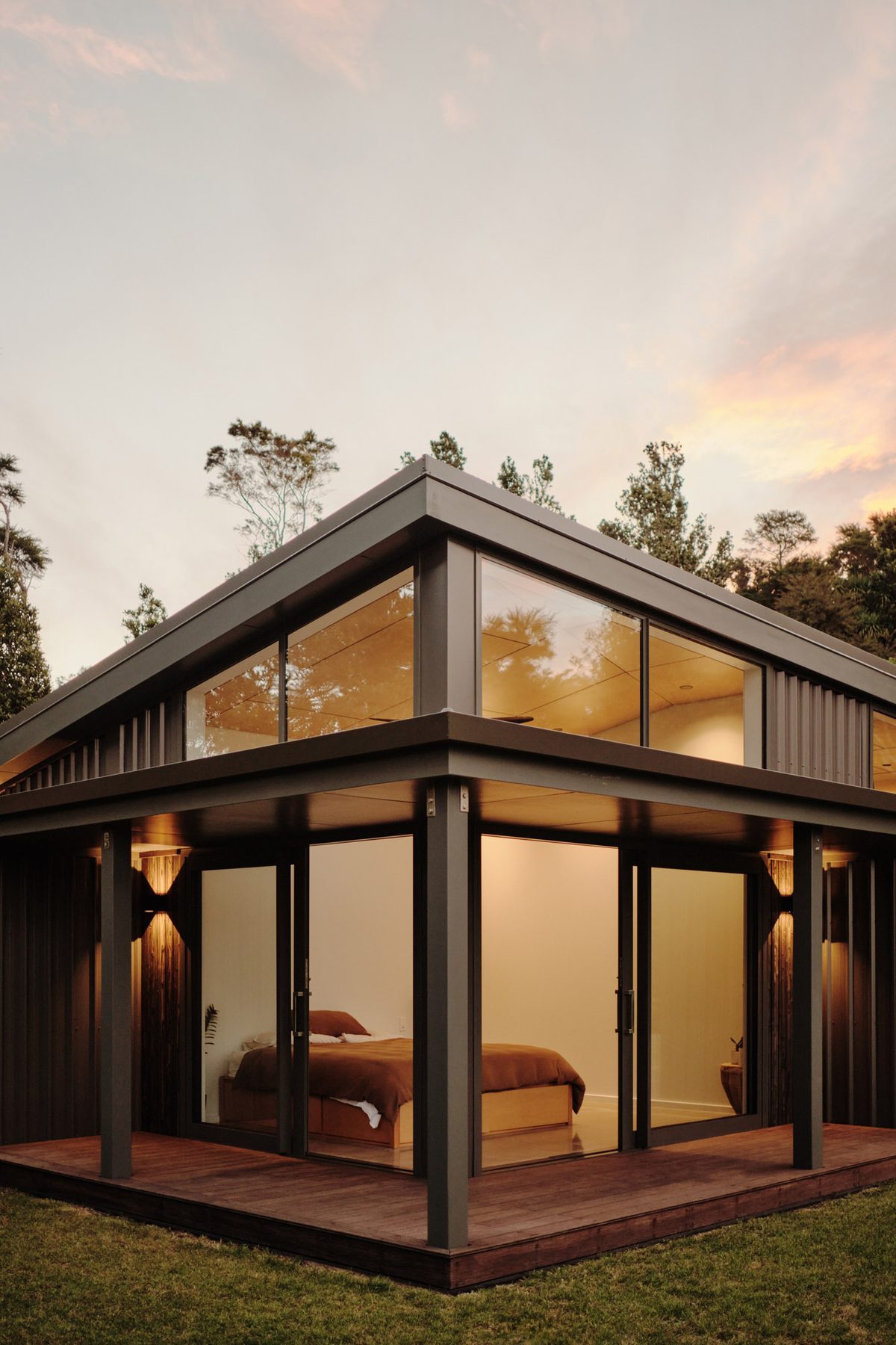 The glazed bedroom corner at dusk.