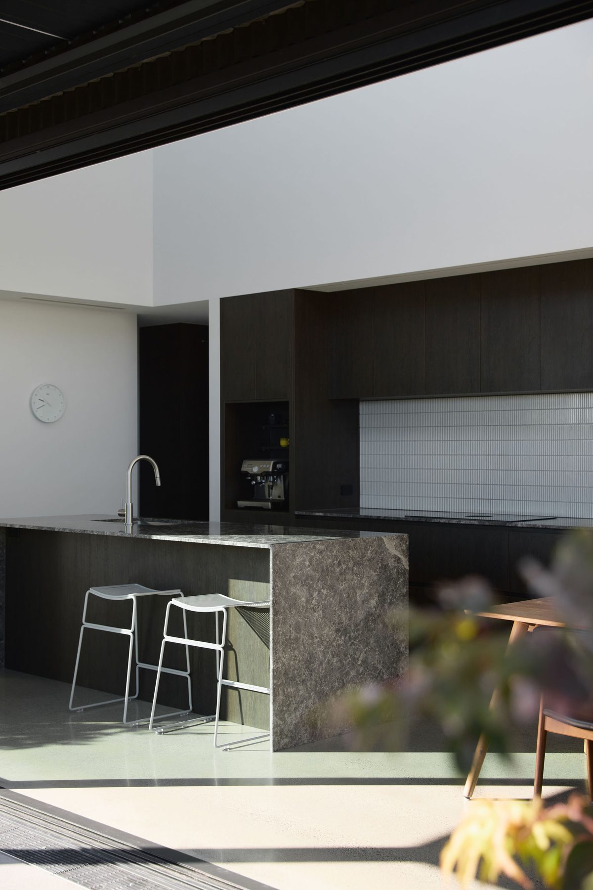 Kitchen flowing to the outdoor room.