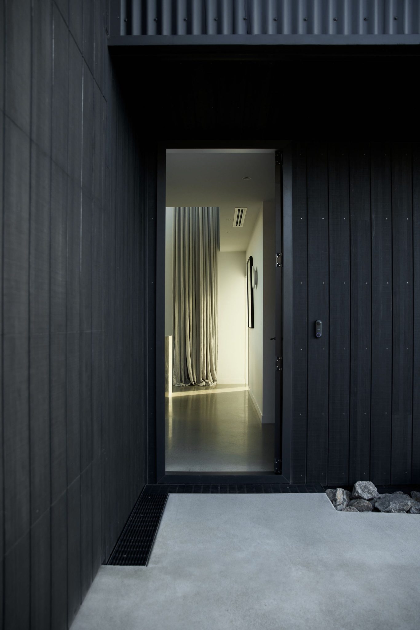 Entry door open and Abodo cladding