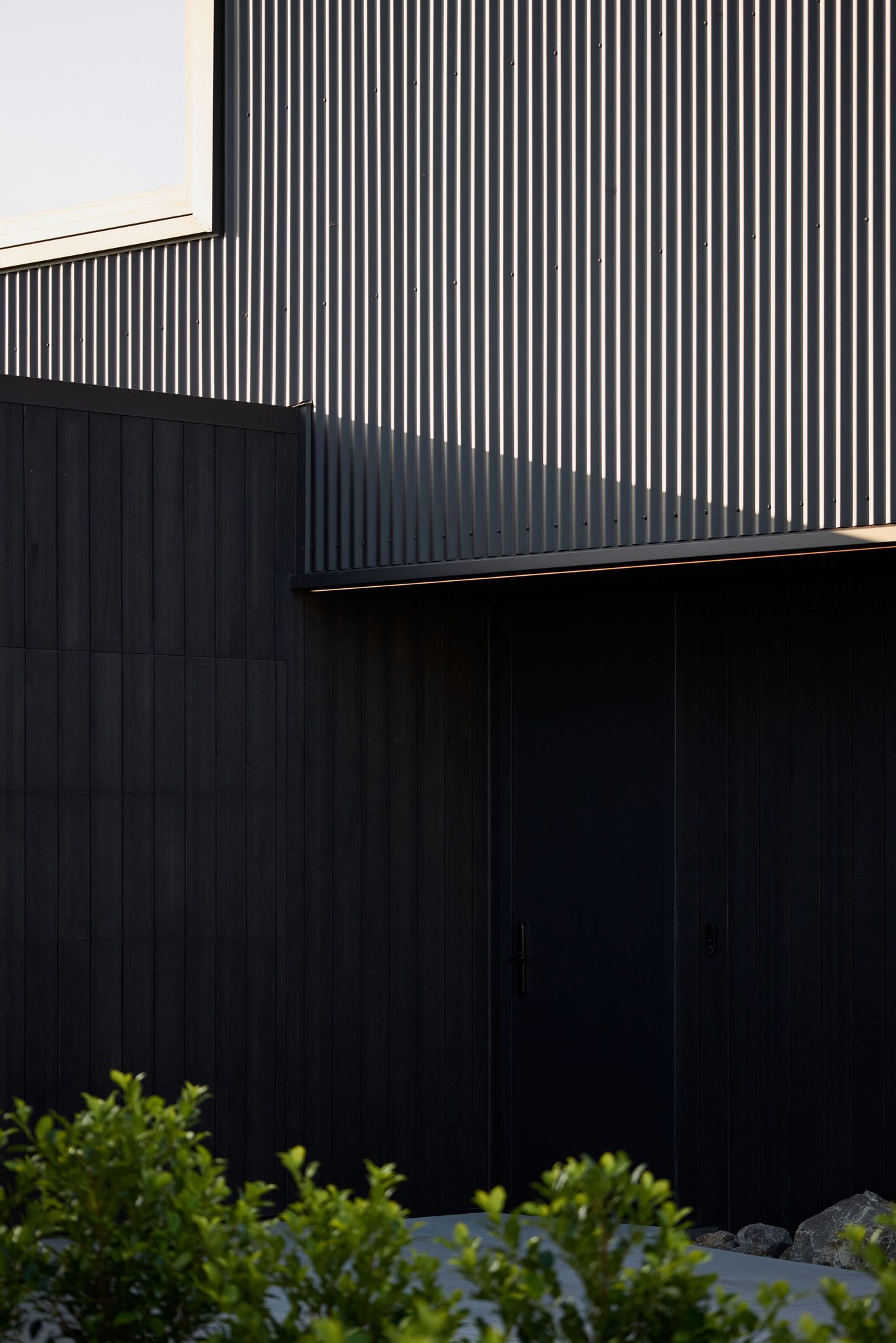 Entrance  overhang and Colorsteel cladding above with soft lighting