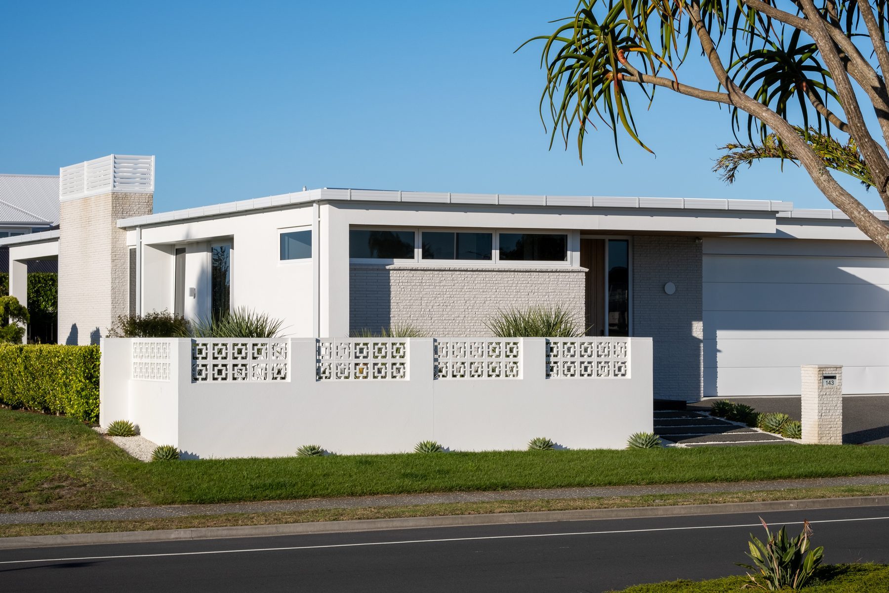 The long white elevation with breeze-block screen.