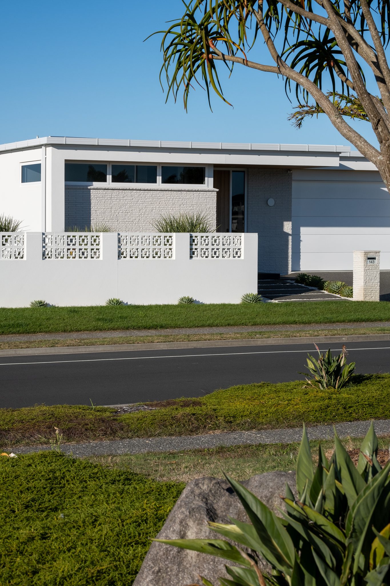 The long white elevation with breeze-block screen.