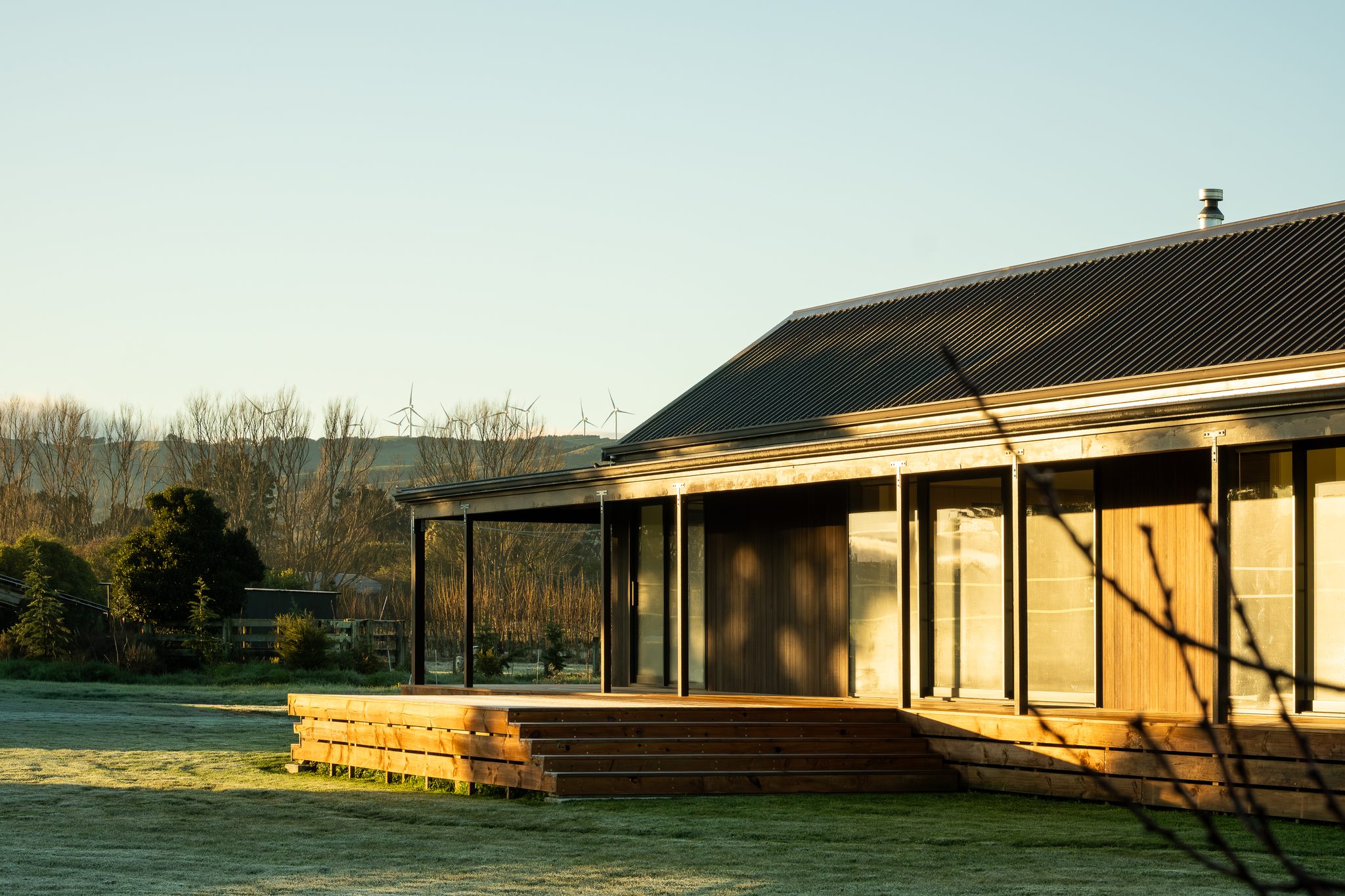  Northern elevation at sunrise and a long verandah homestead in its grounds.