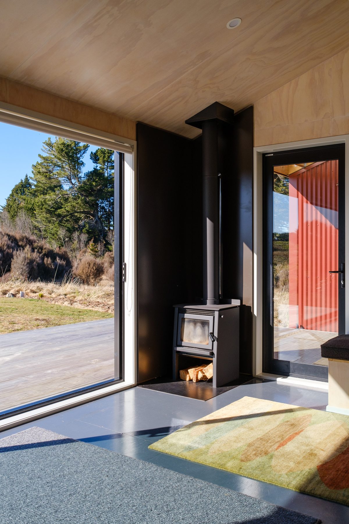 Wood fire and glazing framing the slopes.