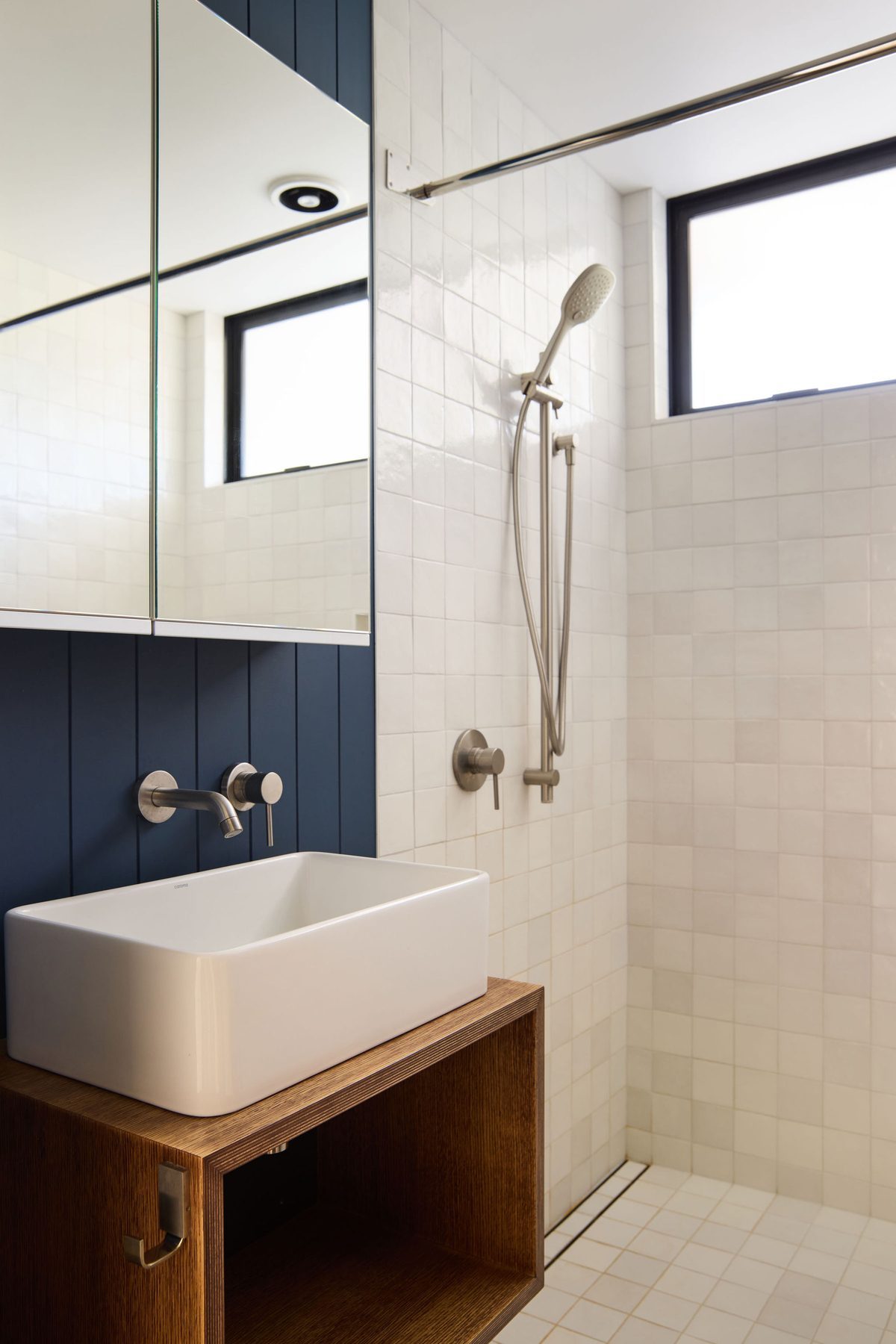 The bathroom in white and navy.