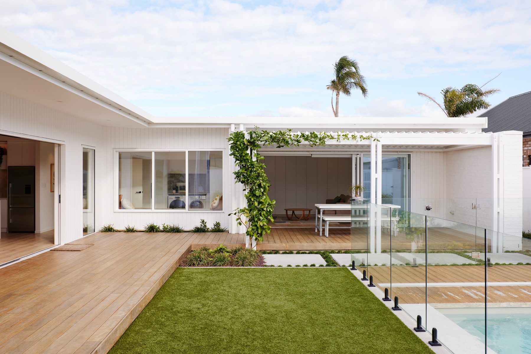 Looking through the living spaces to the lawn and pool.
